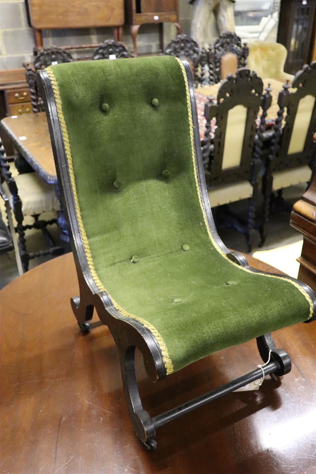 A Victorian ebonised slipper chair